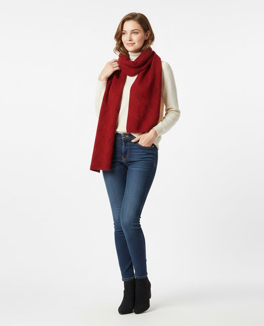 Woman wearing a red scarf, white shirt, blue jeans, and black boots on a white background