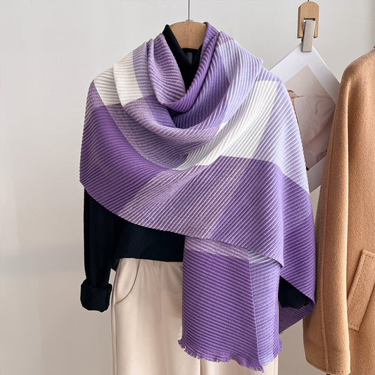 Purple and white striped scarf draped over a mannequin against a neutral background
